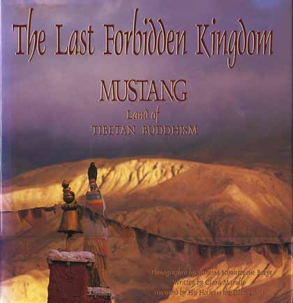 
Prayer flags flutter in the breeze atop the King's palace in Lo Manthang - The Last Forbidden Kingdom Mustang: Land Of Tibetan Buddhism book cover
